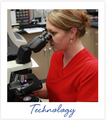 Associate in red scrubs looking through binoculor compound telescope above the word 'Technology'